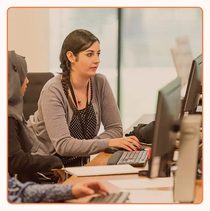 Colleagues working side by side at computer workstations