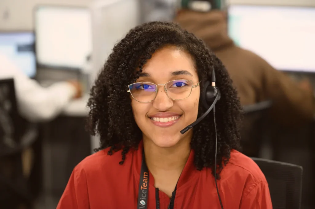 Smiling woman wearing a headset and glasses