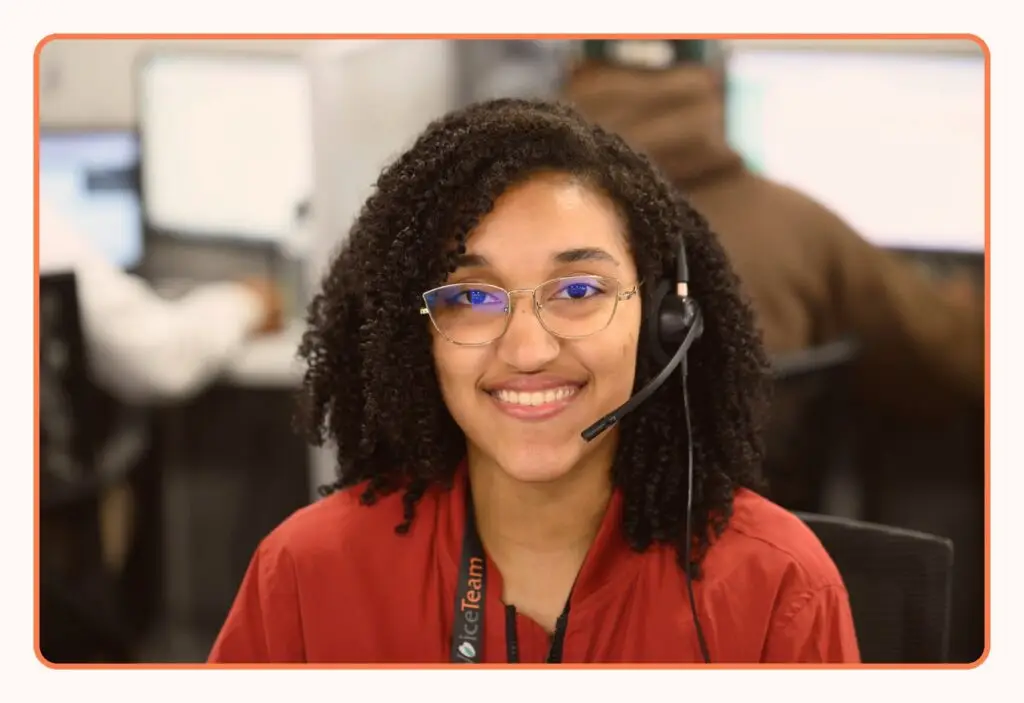 A VoiceTeam agent at a workstation wearing a headset
