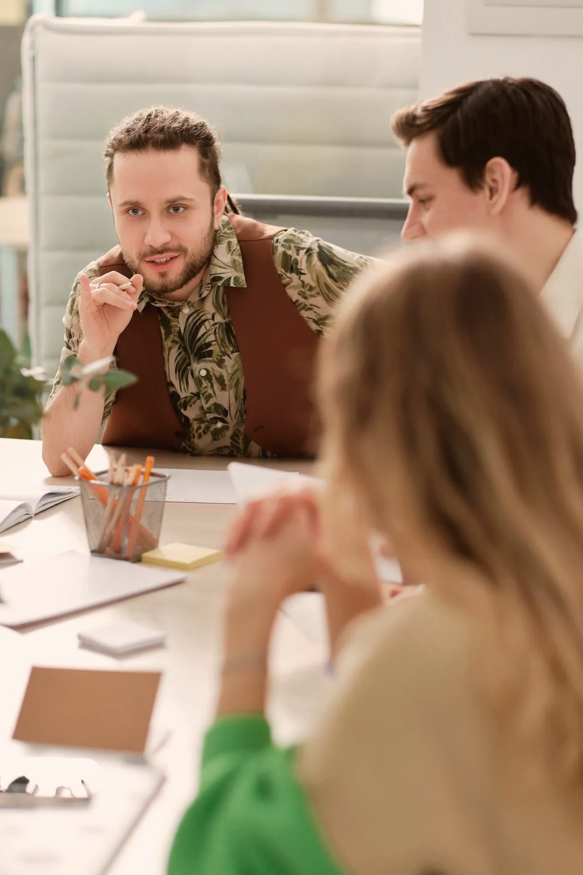 Colleagues talking around a desk