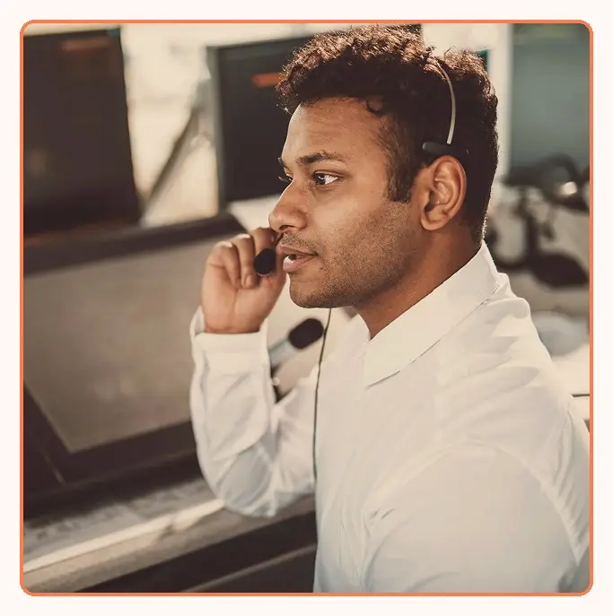A support agent adjusting a headset mic during a call