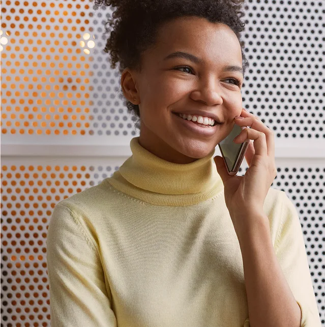 Smiling woman talking on a mobile phone