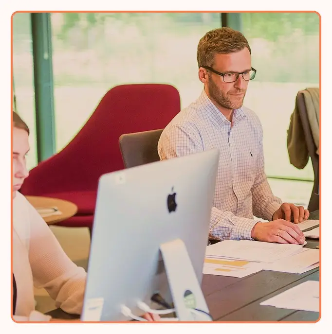 A team working at desktop workstations in an open office