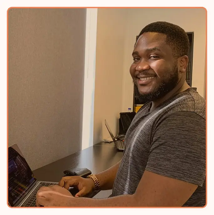 A smiling team member working at his laptop