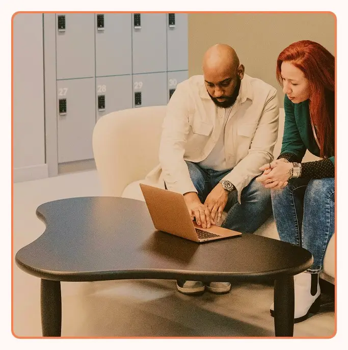 Two colleagues discussing results over a laptop