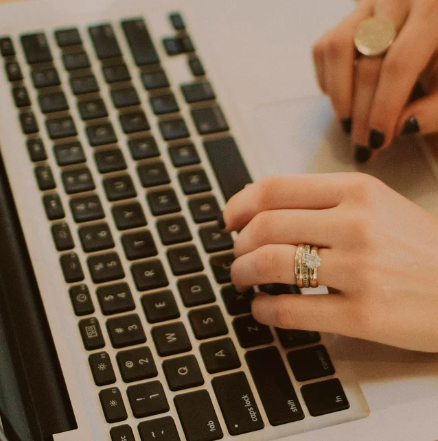 Close-up of a hand on a laptop keyboard