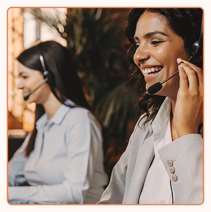 Two support agents with headsets on calls
