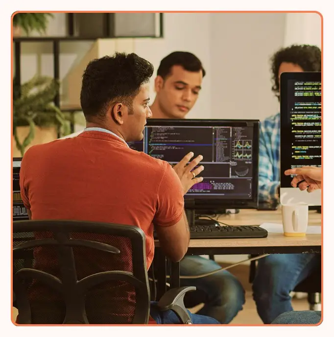 Technical support staff working at multi-monitor workstations