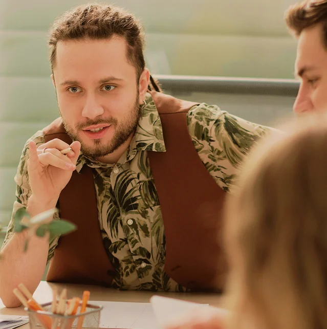 Man talking with colleagues at a table
