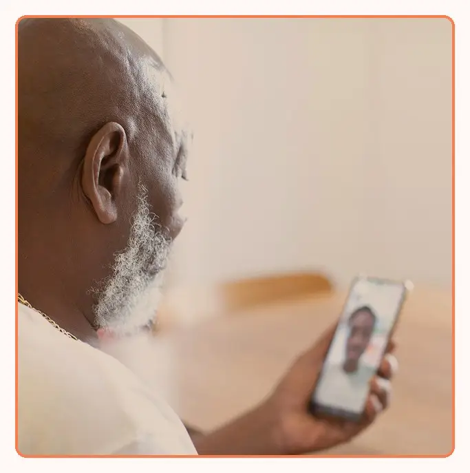 An older patient on a video call on a phone