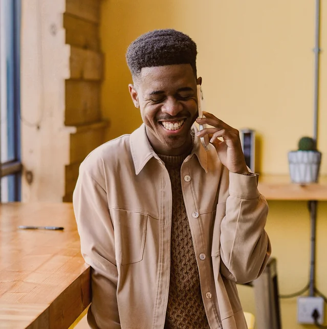 Smiling man talking on a mobile phone