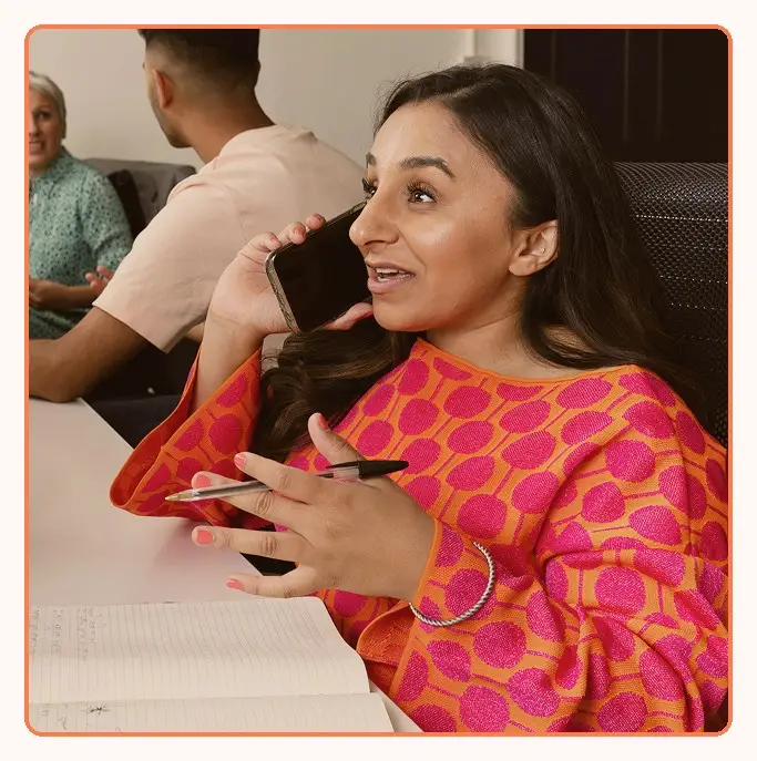 A team member taking a call during a meeting
