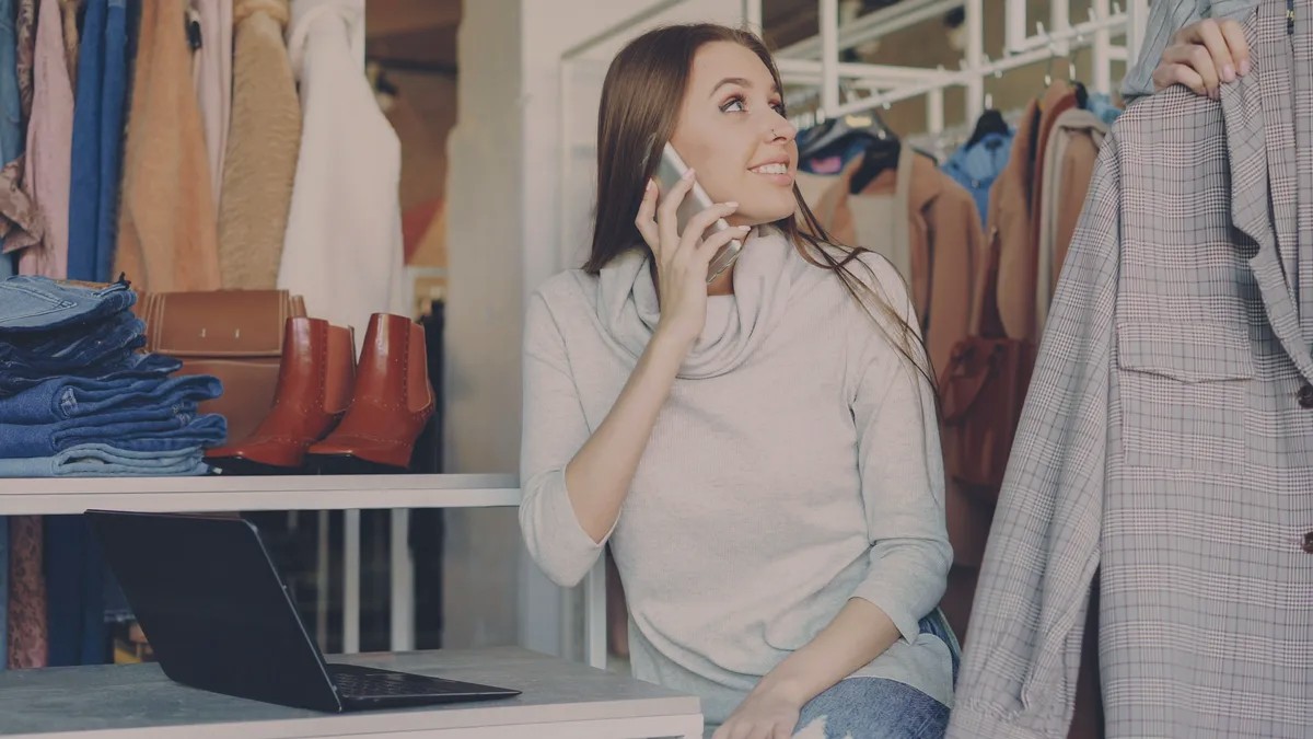 Woman on the phone in a clothing store