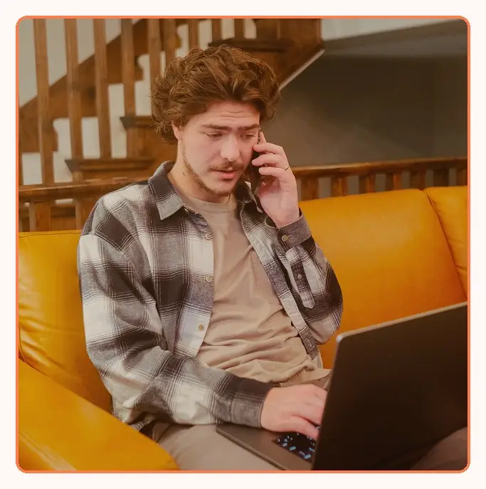 A customer calling support while working on a laptop