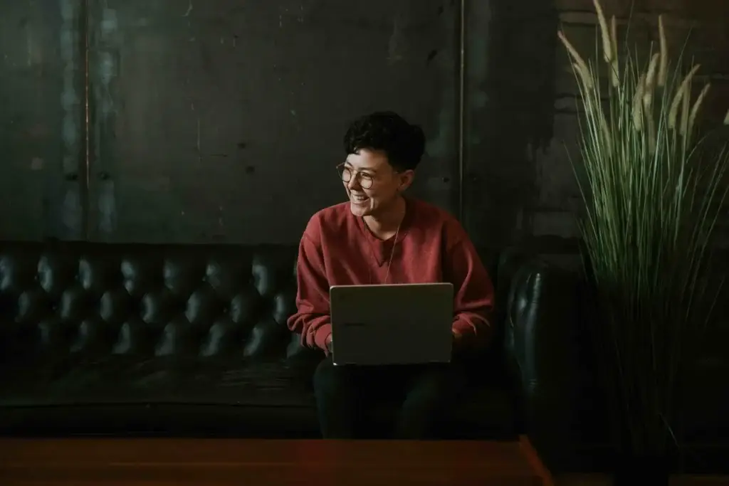 A person working on a laptop in a quiet lounge