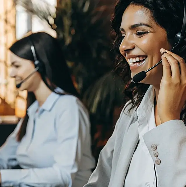 Two support agents with headsets on calls