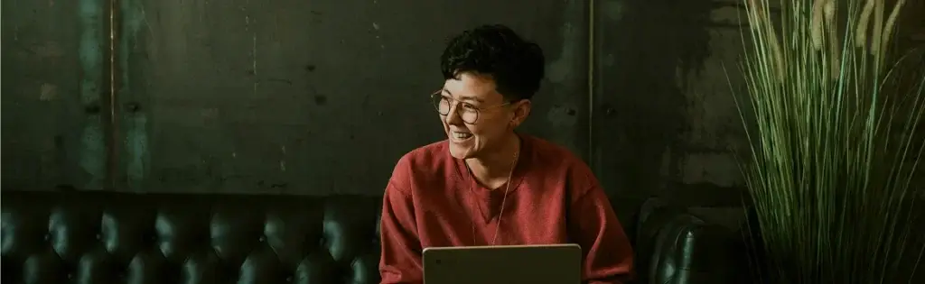 A person working on a laptop in a quiet lounge